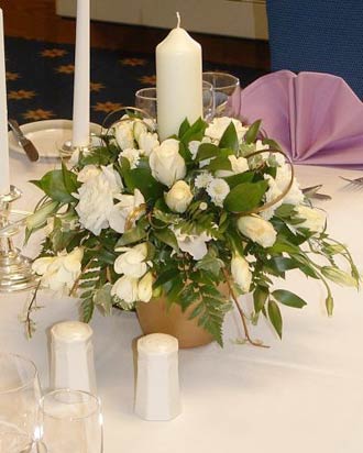 Wedding table arrangementwhite mixed flowers with candle